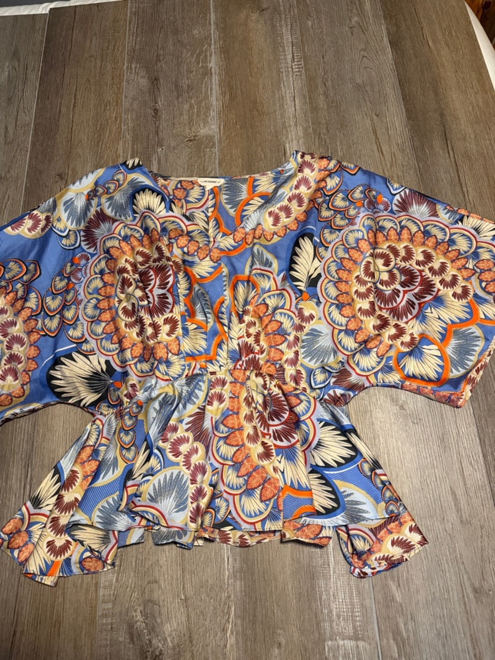 eesome Blue Floral Peplum Blouse with Orange Accents